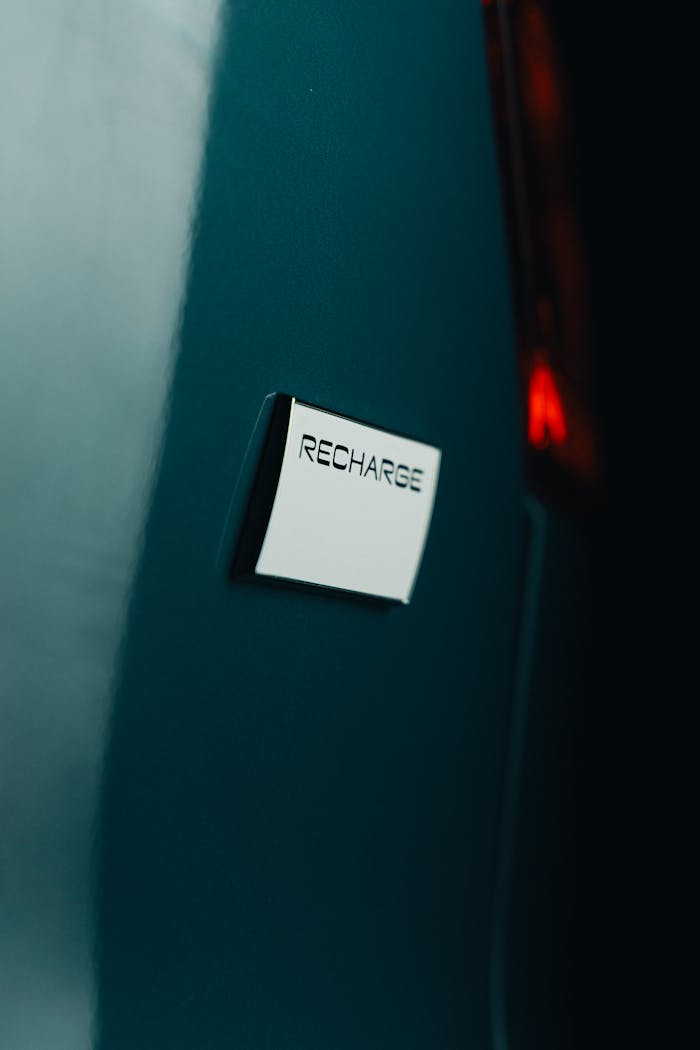 Close-up shot of an electric car in Curitiba, Brazil highlighting the recharge badge.